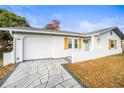 Beautiful single-story home featuring a white exterior, a light-colored roof, and a modern driveway at 6543 Barcelona Blvd, Brooksville, FL 34602