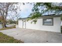 Renovated home with a large concrete patio and a single car driveway at 6699 78Th N Ave, Pinellas Park, FL 33781