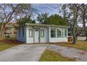 Newly renovated home exterior with light-colored siding and updated landscaping at 6699 78Th N Ave, Pinellas Park, FL 33781