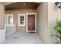 Front entry with red door and small porch at 6944 Towne Lake Rd, Riverview, FL 33578