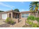 Front entrance with a covered patio and brick walkway at 7643 Vienna Ln, Port Richey, FL 34668
