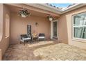 Inviting front porch with hanging plants and seating at 7643 Vienna Ln, Port Richey, FL 34668