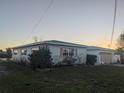 Single-story house with light-colored walls, a garage, and a grassy yard at 7824 3Rd S Ave, St Petersburg, FL 33707