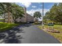 Condo building entrance with lush landscaping at 8174 Terrace Garden N Dr # 110, St Petersburg, FL 33709