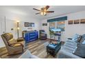 Living room with comfy seating and wood-look floors at 8174 Terrace Garden N Dr # 110, St Petersburg, FL 33709