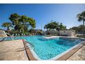 Community pool with lounge chairs and tennis courts at 8174 Terrace Garden N Dr # 110, St Petersburg, FL 33709