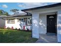 Front entrance of a renovated ranch home with black door at 8577 79Th Ave, Seminole, FL 33777