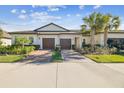 Front view of two-unit home with two-car garages at 10374 Echo Dock Loop, San Antonio, FL 33576
