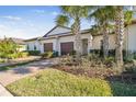 Three-unit home with two-car garages and palm trees at 10374 Echo Dock Loop, San Antonio, FL 33576
