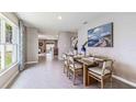 Bright dining room with wood table and four chairs, view into living area at 10551 Dusty Boot Rd, Land O Lakes, FL 34638