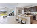 Open kitchen boasting granite countertops, dark cabinetry, and stainless steel appliances at 10558 Dusty Boot Rd, Land O Lakes, FL 34638