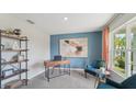Bright home office with built-in shelving and comfortable seating at 10562 Farm Hill Ave, Land O Lakes, FL 34638
