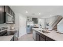 Modern kitchen with stainless steel appliances and an island at 10562 Farm Hill Ave, Land O Lakes, FL 34638