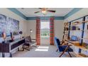 Bright bedroom with a built-in workspace and colorful decor at 10574 Farm Hill Ave, Land O Lakes, FL 34638
