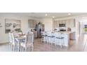 Open kitchen with stainless steel appliances and an island at 10574 Farm Hill Ave, Land O Lakes, FL 34638