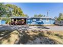 Blue house with covered patio and large backyard at 14045 21St St, Dade City, FL 33525