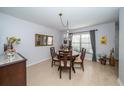 Elegant dining room features a round table with four chairs and chandelier at 17546 Fairmeadow Dr, Tampa, FL 33647