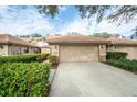 Townhome with attached garage and neatly landscaped front at 17546 Fairmeadow Dr, Tampa, FL 33647