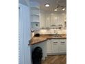 White cabinets, granite countertops, and a double sink characterize this kitchen at 1799 N Highland Ave # 44, Clearwater, FL 33755