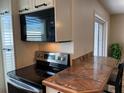 Stainless steel appliances and a breakfast bar highlight this updated kitchen at 1799 N Highland Ave # 44, Clearwater, FL 33755