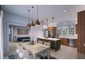 Modern kitchen with island, stainless steel appliances, and dining area at 2550 1St N Ave, St Petersburg, FL 33713