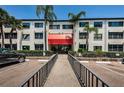 Condo building entrance with red awning and gated access at 2587 Countryside Blvd # 6303, Clearwater, FL 33761