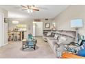Living room features gray sectional and kitchen pass-through at 3141 Lake Pine Way # D2, Tarpon Springs, FL 34688