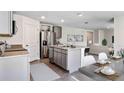 Modern kitchen with gray cabinets, granite counters, and an island at 33182 Osprey Peak Way, San Antonio, FL 33576