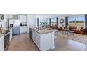 Open concept kitchen with island and stainless steel appliances at 5246 Salt Marsh Rd, Wimauma, FL 33598