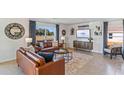 Living room featuring leather couches and a large TV at 5246 Salt Marsh Rd, Wimauma, FL 33598