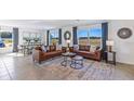 Spacious living room with leather sofas and large windows at 5246 Salt Marsh Rd, Wimauma, FL 33598