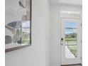 Bright entryway with glass door and modern art at 5249 Salt Marsh Rd, Wimauma, FL 33598