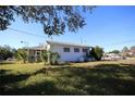 View of the home's side with a screened porch at 801 Woodruff Ave, Clearwater, FL 33756