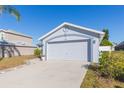 Exterior view of a house with a two car garage at 10401 Barnett Loop, Port Richey, FL 34668