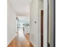 Bright hallway with hardwood floors leading to modern kitchen at 111 N 12Th St # 1812, Tampa, FL 33602