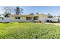 Newly renovated house with green lawn and white fence at 11398 88Th Ave, Seminole, FL 33772