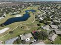 Aerial view showcasing home's location in a community near a golf course and pond at 1318 Leland Dr, Sun City Center, FL 33573