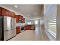 Modern kitchen with stainless steel appliances and wood cabinets at 1610 Bonita Bluff Ct, Ruskin, FL 33570