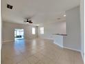 Spacious living area with tile floors and access to the backyard at 1610 Bonita Bluff Ct, Ruskin, FL 33570