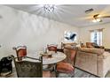 Small dining area with round glass table and four chairs at 16314 Swan View Cir, Odessa, FL 33556
