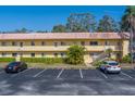 Condo building with parking lot and mature trees at 2003 Greenbriar Blvd # 17, Clearwater, FL 33763