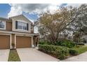 Two-story townhome with two-car garage and manicured landscaping at 2044 Santa Catalina Ln Dr # 2044, Riverview, FL 33578