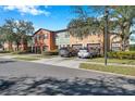 Street view of colorful townhouses with cars parked in driveways at 2517 Edgewater Falls Dr, Brandon, FL 33511