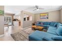 Open living space featuring a comfortable sectional sofa and kitchen view at 3064 Pinetree St, Port Charlotte, FL 33952