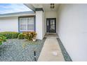 Front entryway with walkway, landscaping, and a covered porch at 3127 Ivyhill Ct, Holiday, FL 34691