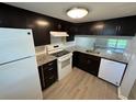 Updated kitchen with granite countertops and white appliances at 5035 Bordeaux Village Pl # 101, Tampa, FL 33617