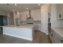 Modern kitchen with large island, stainless steel appliances, and white cabinets at 6123 Hidden Branch Dr, Apollo Beach, FL 33572
