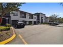 View of building showing parking and landscaping at 8517 Island Breeze Ln # 207, Temple Terrace, FL 33637