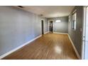 Spacious living room featuring light brown wood flooring and gray walls at 1005 E Fern St, Tampa, FL 33604