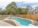 Inviting kidney-shaped pool with concrete decking at 102 Shoreview Ln, Oldsmar, FL 34677